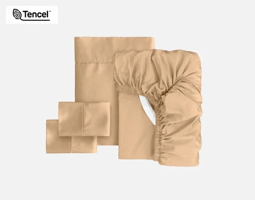 The full contents of our Eucalyptus Luxe Sheet Set in Sandalwood sitting against a solid background, including a fitted sheet, flat sheet, and two pillowcases.