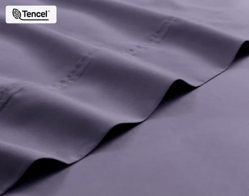 Close-up on the fitted and flat sheet of our Eucalyptus Luxe Sheet Set in Purple Basil.