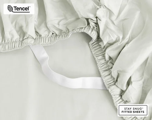 Close-up on the elastic snug fit band on the corner of our Eucalyptus Luxe Fitted Sheet in Oyster.