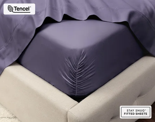 Close-up on the corner of a mattress with our Eucalyptus Luxe Fitted Sheet in Purple Basil to show its snug fit.