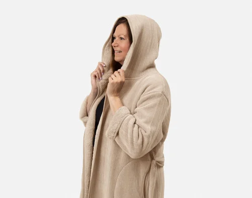 Closer view of woman wearing our Chenille Sherpa Bathrobe in Dune against a solid white background with hood raised over her head.