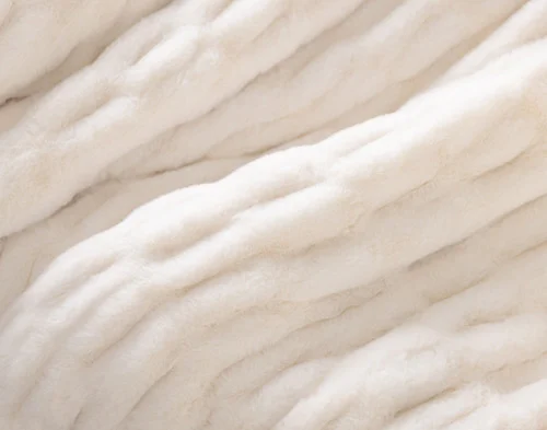 Close up on our Cocoon Plush Throw in Cream to show its textured surface.