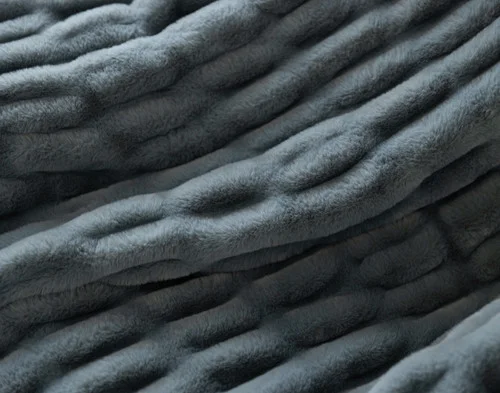 Close up on our Cocoon Plush Throw in Juniper to show its textured surface.