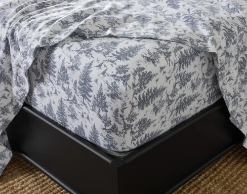 Close-up of the fitted sheet from our Winter Toile Organic Cotton Flannel Sheet Set fitted over a mattress.