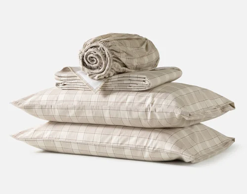 The contents of our Cabin Check Organic Cotton Flannel Sheet Set, including two pillowcases, a fitted sheet, and a flat sheet.