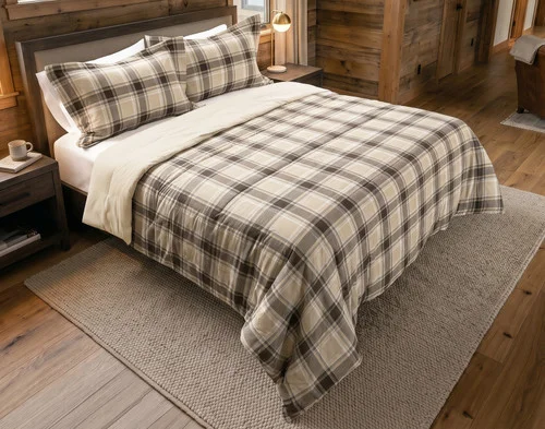 Angled view of our Timberline Cotton Flannel Comforter Set dressed over a queen bed in a cabin bedroom.