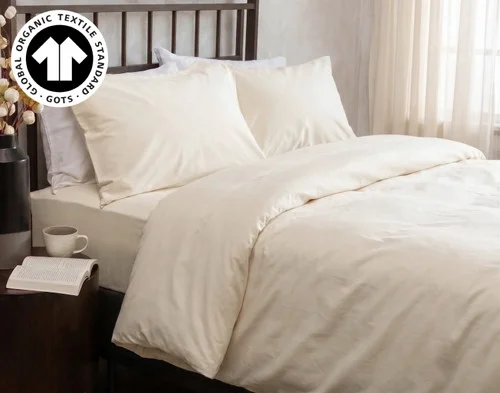 Side view of our Undyed & Unbleached Organic Cotton Duvet Cover over a queen bed.