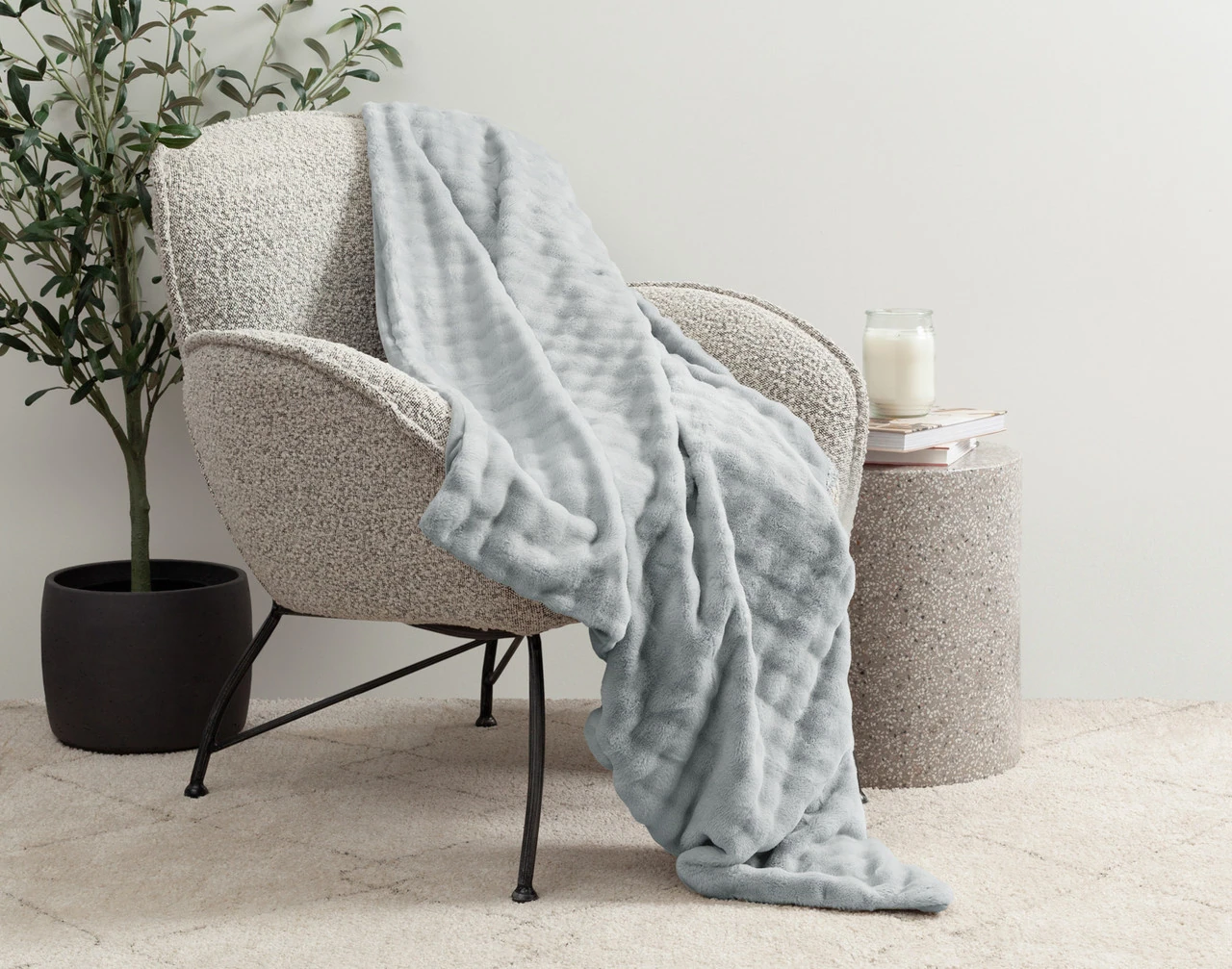 Our Grey Dove Mini Bubble Throw draped over a grey chair.