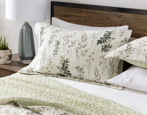 Front view of the pillow shams from our Fairfield Cotton Quilt Set sitting against a headboard.