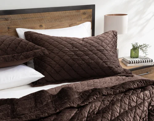 Angled view of our Jasper Quilt Set dressing the head of a bed/