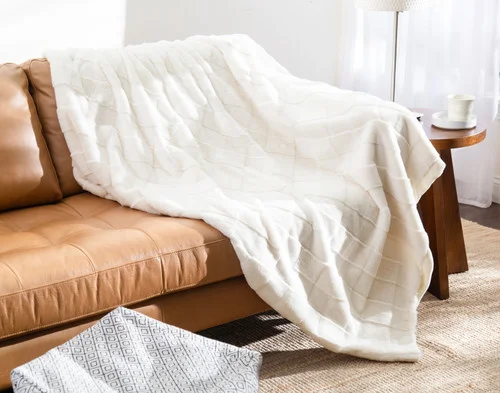 Our Etched Check Throw - Frost draped on a brown couch.