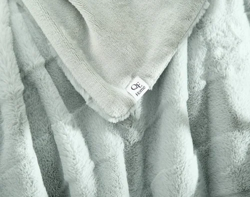 Close up on the folded surface of our Etched Check Throw - Silver Sage.