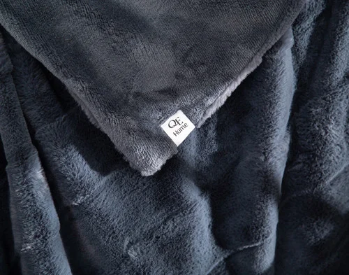 Close up on the folded surface of our Etched Check Throw - Night Tide.