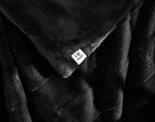 Close up on the folded surface of our Etched Check Throw - Black Ink.