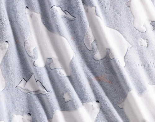 Close-up of the fleece fabric ruffled on our Polar Cove Glow in the Dark Throw.