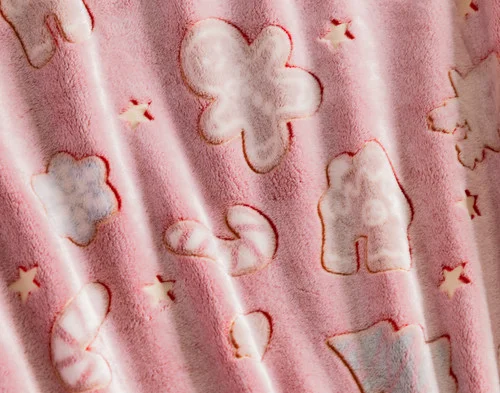Close-up of the fleece fabric ruffled on our Holiday Huddle Glow in the Dark Throw.