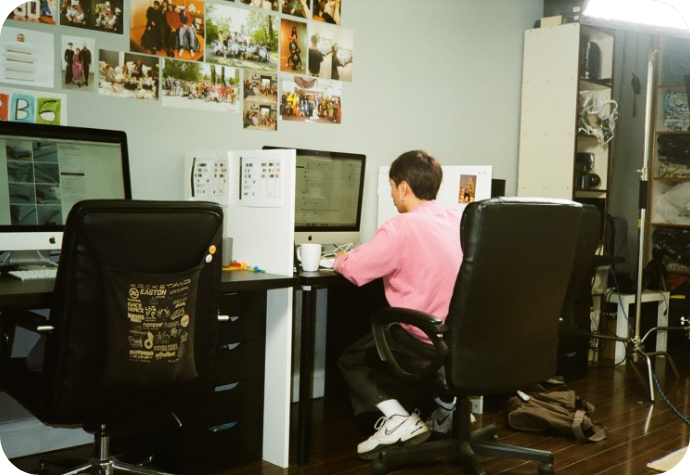 A QE Home photographer reviews and organizes photos at their desk, getting them ready for publication.