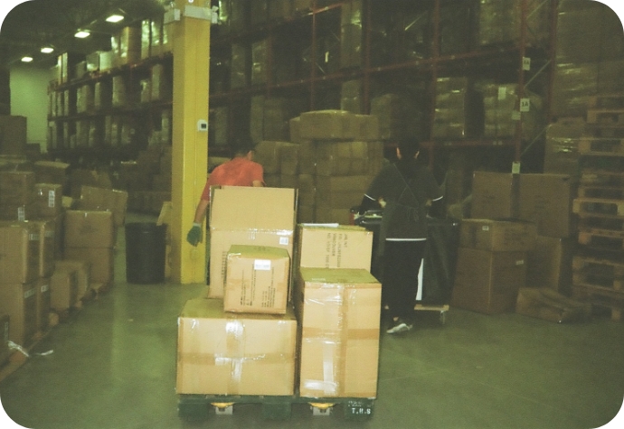 Members of the QE Home fulfillment team moves boxes within the warehouse.