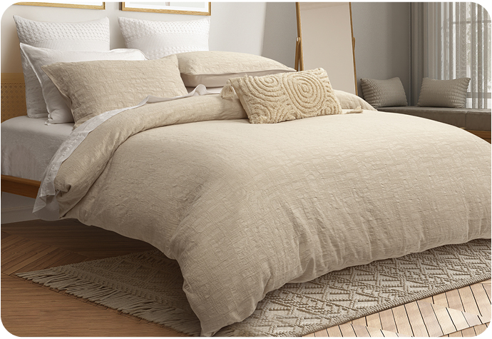 Our Stonehaven Bedding Collection features a beige duvet cover with a textured finish and coordinating beige pillow shams