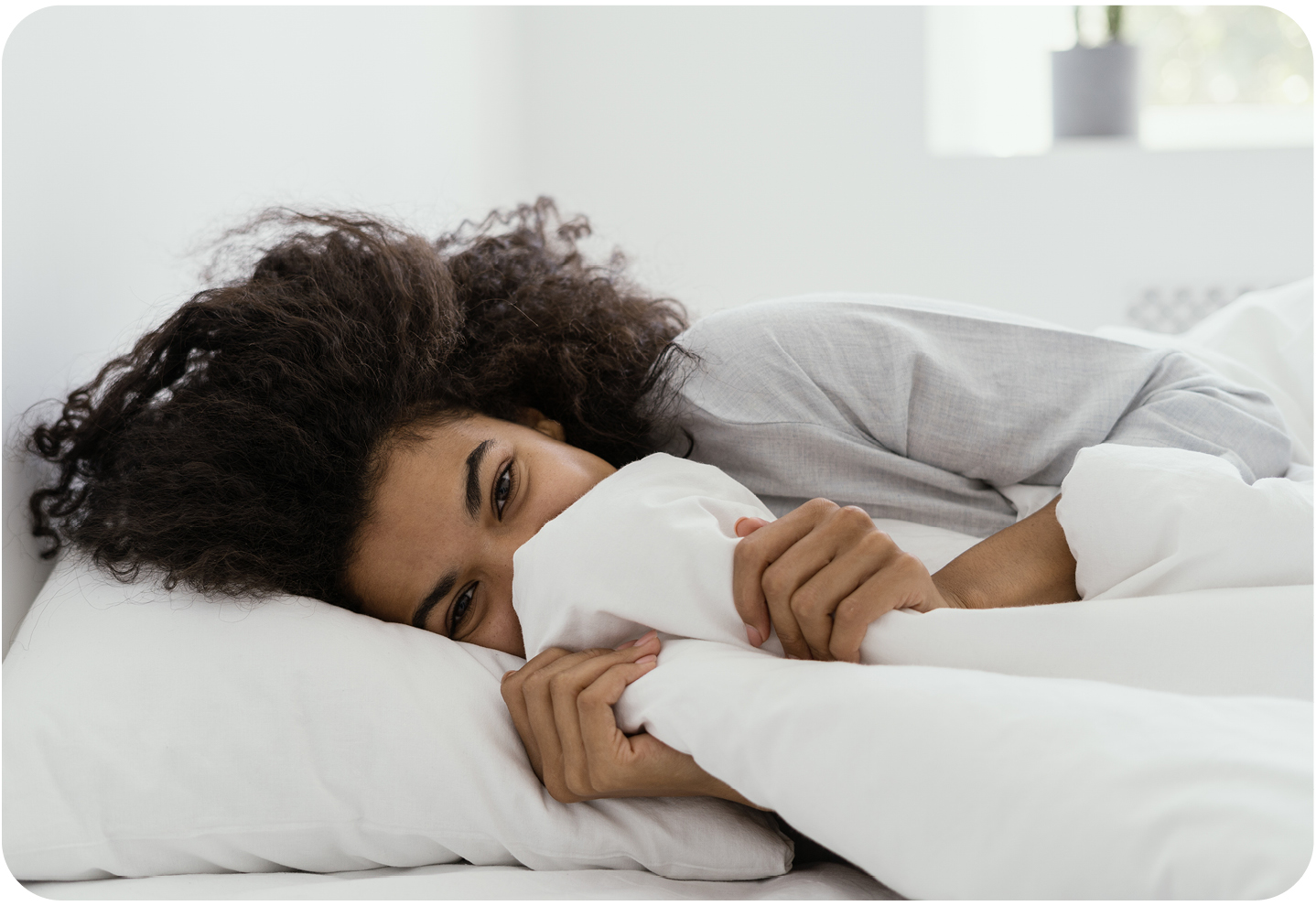 Femme allongée dans un lit blanc et propre draps