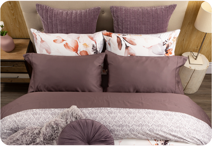 Top view of our Bergen Duvet Cover over a queen bed, showcasing its pillow shams alongside our Ribbed Chenille Euro Pillow Shams in Mauve Purple, our Beechbliss Sheet Set in Inkberry, and coordinating Bergen pillow shams.