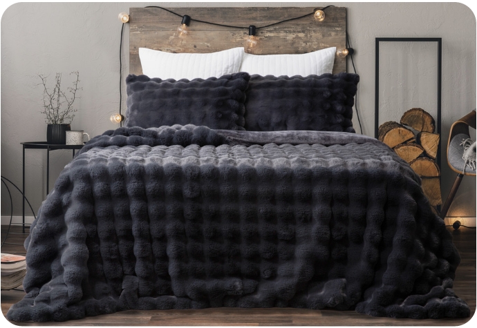 Our Bubble Faux Fur Comforter Set in Soot shown on a bed.