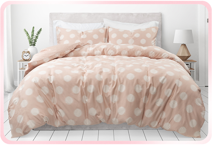 Our pink and white Organic Cotton Duvet Cover Set in Sloane is pictured in a white bedroom.
