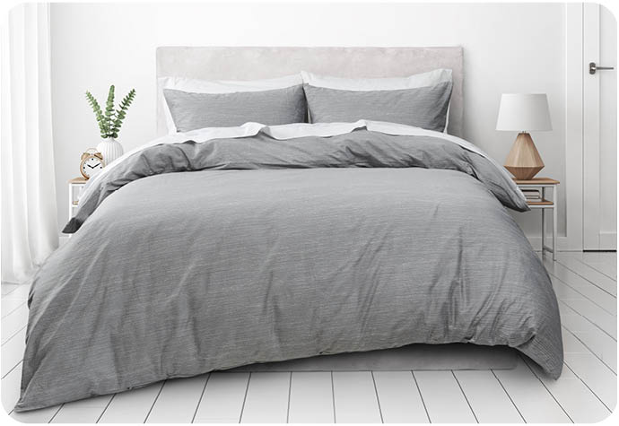 Our Flux Organic Cotton Duvet Cover Set dressed on a bed with white sheets.
