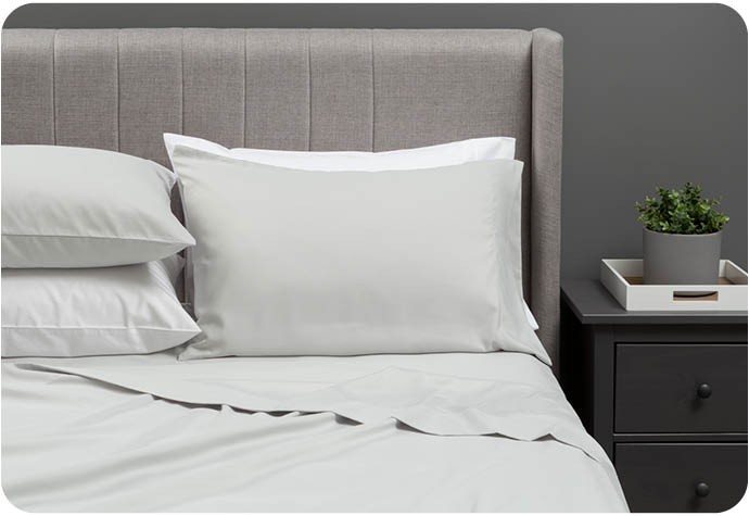 Our Recycled Microfiber Sheet Set in Vapor Grey styled in a grey bedroom.