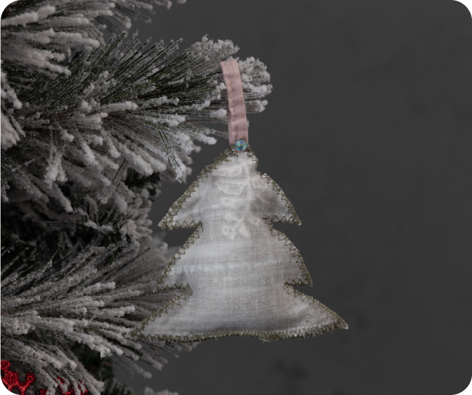 A close up shot of a DIY Fabric Scrap Holiday Decoration hanging on a Christmas tree.